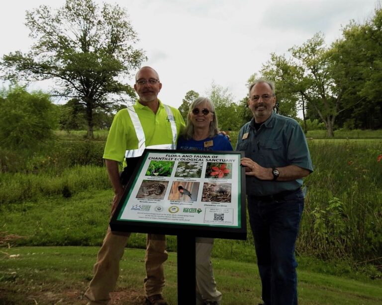 Pictured with an educational kiosk are John Mcculloch (MC StormWater Services), Ernie McLaney and Donna Bolls (CWS)